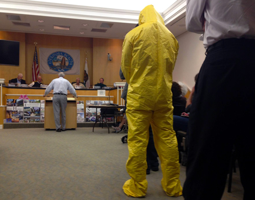 Activist in Hazmat suit at hearing Keep Hermosa Hermosa Campaign to Stop Oil Drilling