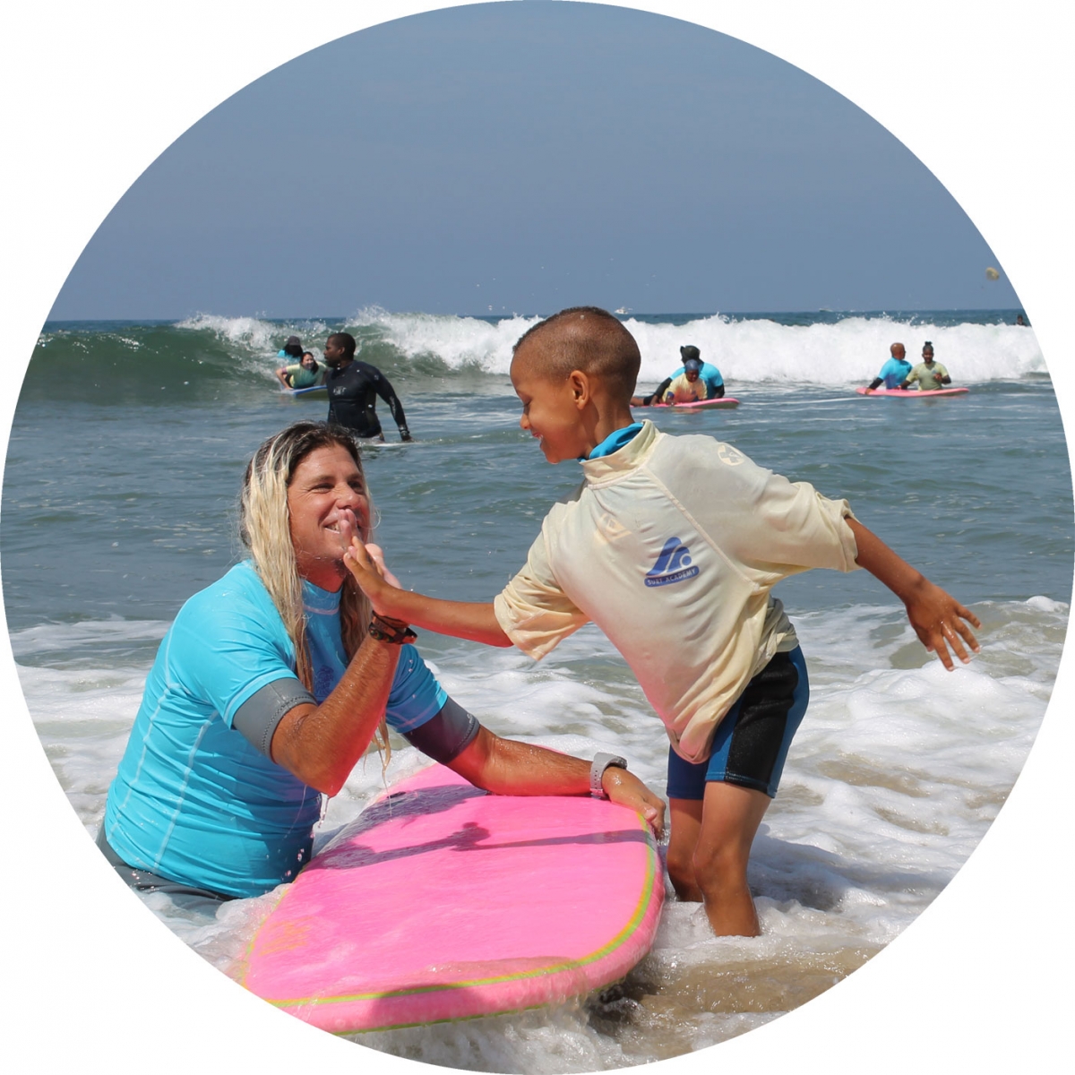 Surfing lesson high-five at Nick Gabaldon Day
