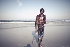 Surfer covered in oil